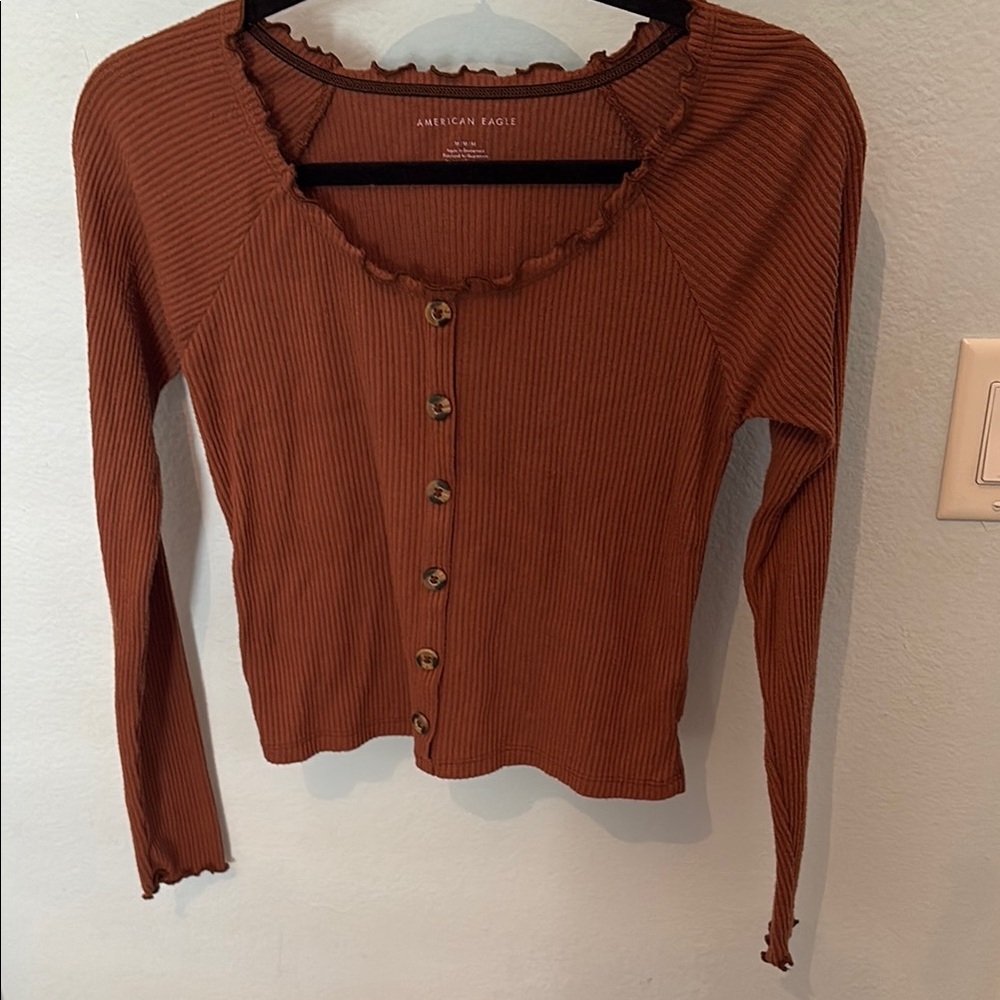 Orange/rust color long sleeve top with buttons